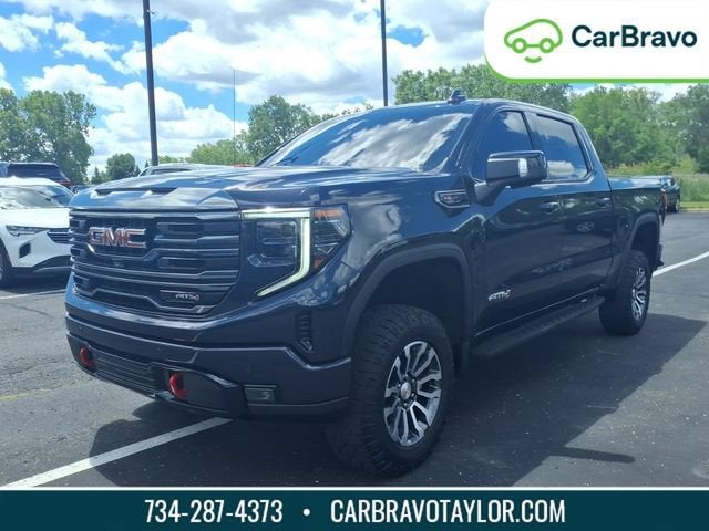 2023 GMC Sierra 1500 AT4 in Titanium Rush Metallic — front three-quarter view